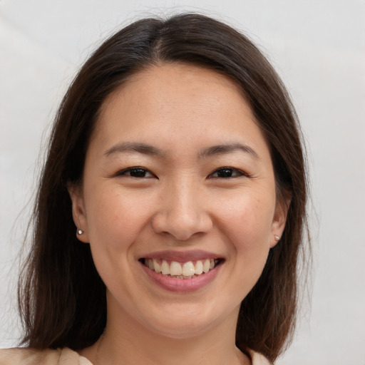 Joyful white young-adult female with medium  brown hair and brown eyes
