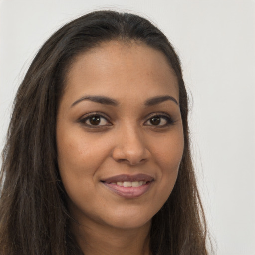 Joyful latino young-adult female with long  brown hair and brown eyes