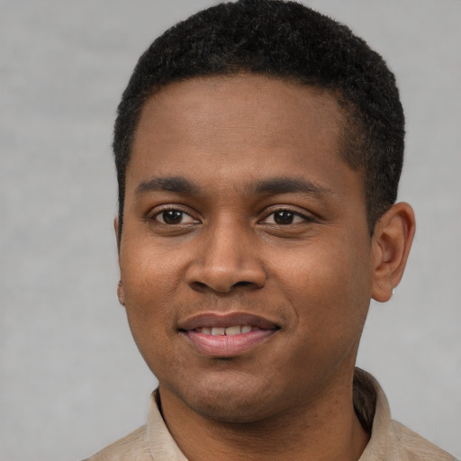 Joyful black young-adult male with short  black hair and brown eyes