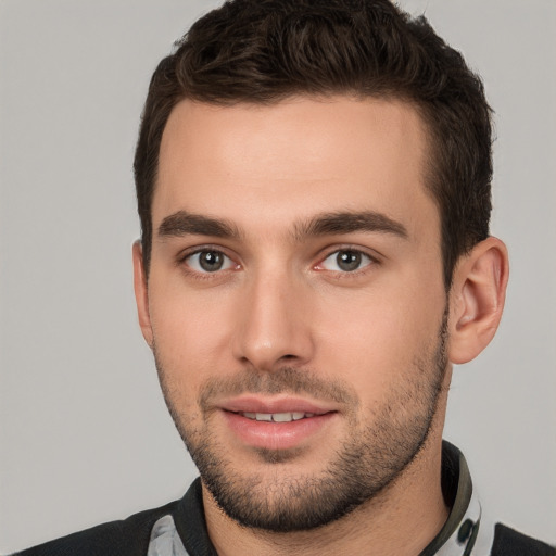 Joyful white young-adult male with short  brown hair and brown eyes