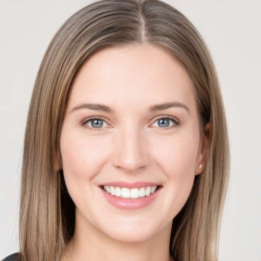 Joyful white young-adult female with long  brown hair and grey eyes