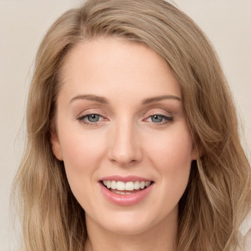 Joyful white young-adult female with long  brown hair and blue eyes