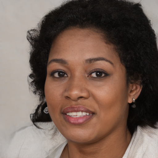 Joyful black young-adult female with medium  brown hair and brown eyes
