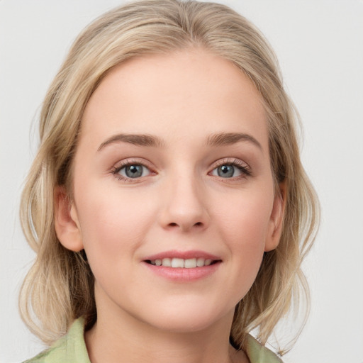 Joyful white young-adult female with medium  brown hair and blue eyes