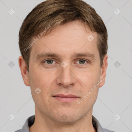 Joyful white adult male with short  brown hair and grey eyes