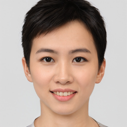 Joyful asian young-adult female with short  brown hair and brown eyes