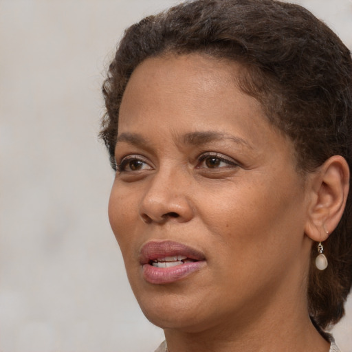 Joyful black adult female with short  brown hair and brown eyes