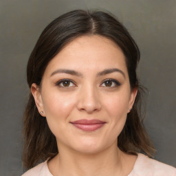 Joyful white young-adult female with medium  brown hair and brown eyes