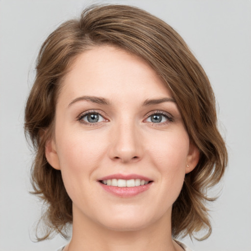 Joyful white young-adult female with medium  brown hair and green eyes