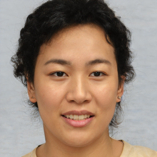 Joyful asian young-adult female with short  brown hair and brown eyes