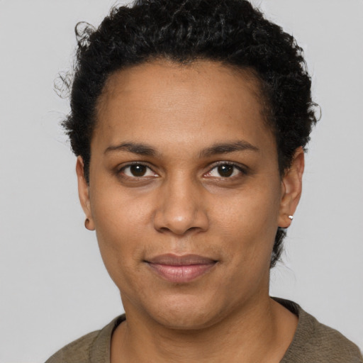 Joyful black young-adult female with short  brown hair and brown eyes