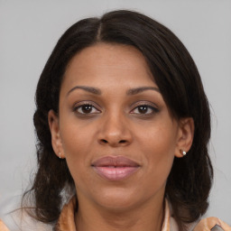 Joyful black adult female with medium  brown hair and brown eyes