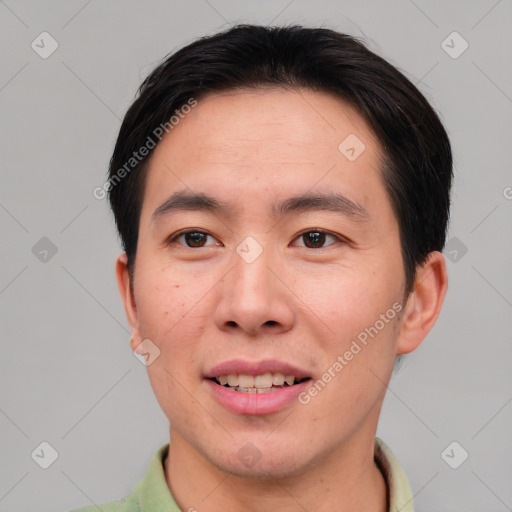 Joyful asian young-adult male with short  brown hair and brown eyes