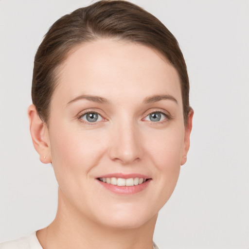 Joyful white young-adult female with short  brown hair and grey eyes