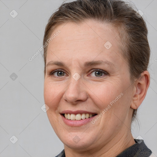 Joyful white adult female with medium  brown hair and brown eyes