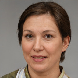 Joyful white adult female with medium  brown hair and brown eyes