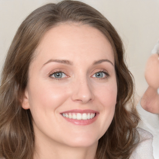 Joyful white young-adult female with medium  brown hair and green eyes