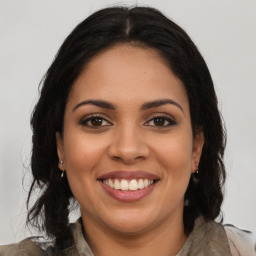 Joyful latino young-adult female with long  brown hair and brown eyes