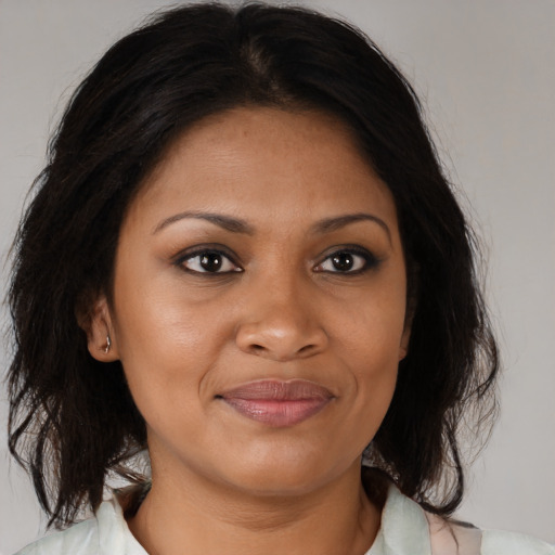 Joyful black young-adult female with medium  brown hair and brown eyes