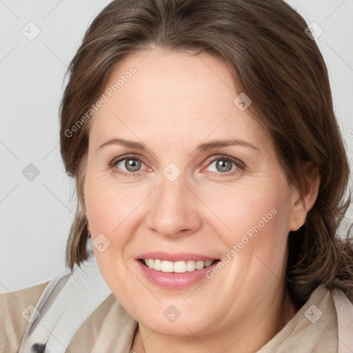 Joyful white adult female with medium  brown hair and grey eyes