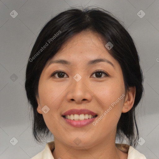 Joyful asian adult female with medium  brown hair and brown eyes