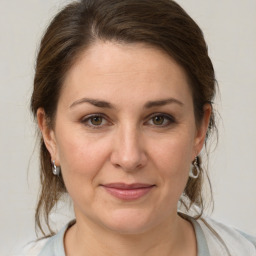 Joyful white adult female with medium  brown hair and brown eyes