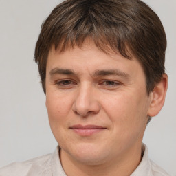 Joyful white young-adult male with short  brown hair and brown eyes