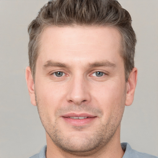 Joyful white adult male with short  brown hair and grey eyes