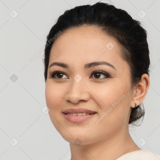 Joyful latino young-adult female with medium  brown hair and brown eyes