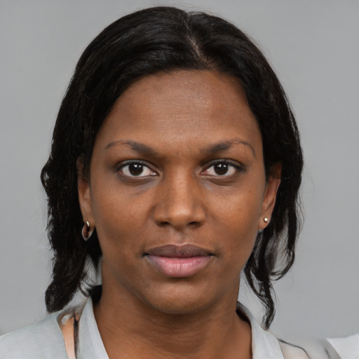 Neutral black young-adult female with medium  brown hair and brown eyes