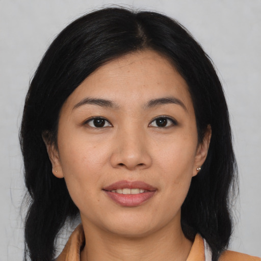 Joyful asian young-adult female with medium  black hair and brown eyes