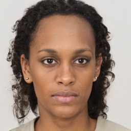 Neutral black young-adult female with medium  brown hair and brown eyes