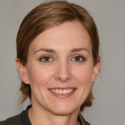 Joyful white young-adult female with medium  brown hair and blue eyes