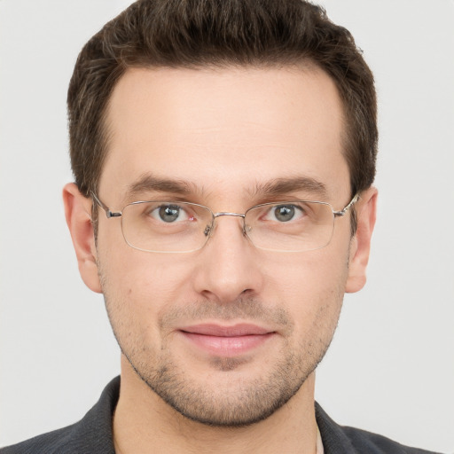 Joyful white young-adult male with short  brown hair and grey eyes