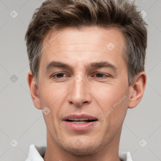 Joyful white adult male with short  brown hair and brown eyes