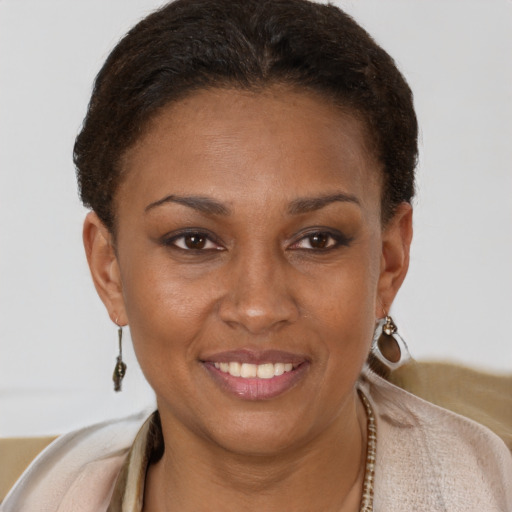 Joyful black young-adult female with short  brown hair and brown eyes
