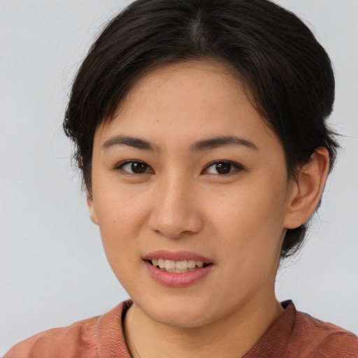 Joyful asian young-adult female with medium  brown hair and brown eyes