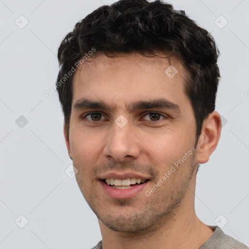 Joyful white young-adult male with short  black hair and brown eyes