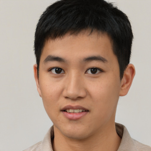 Joyful asian young-adult male with short  black hair and brown eyes
