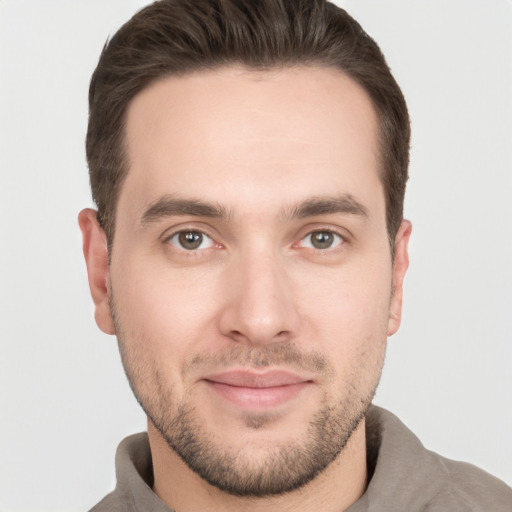 Joyful white young-adult male with short  brown hair and brown eyes