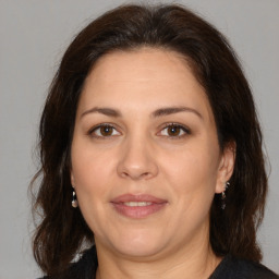 Joyful white adult female with medium  brown hair and brown eyes