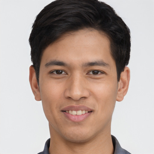 Joyful asian young-adult male with short  black hair and brown eyes