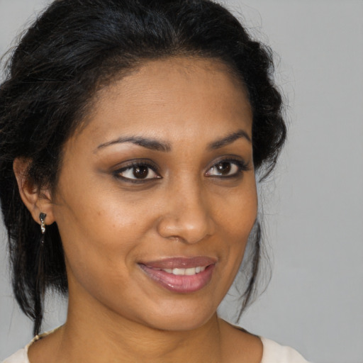 Joyful black young-adult female with medium  brown hair and brown eyes