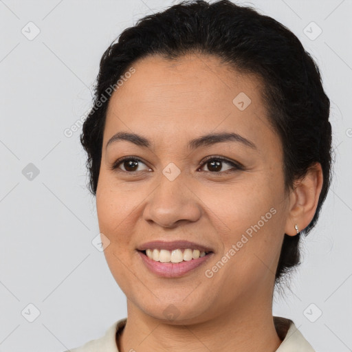 Joyful latino young-adult female with short  brown hair and brown eyes