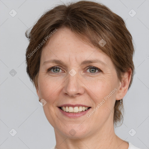 Joyful white adult female with short  brown hair and grey eyes