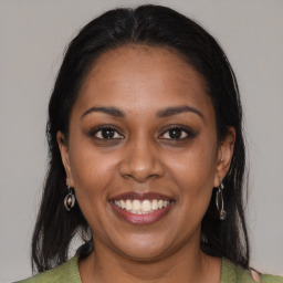 Joyful black young-adult female with medium  brown hair and brown eyes