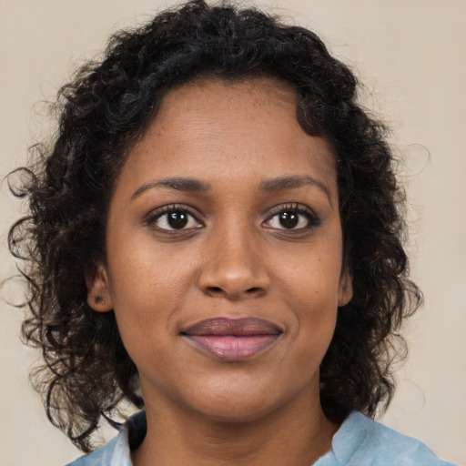 Joyful black young-adult female with medium  brown hair and brown eyes