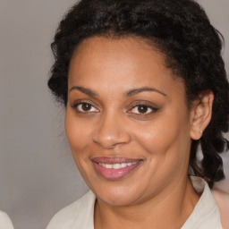 Joyful black young-adult female with medium  brown hair and brown eyes