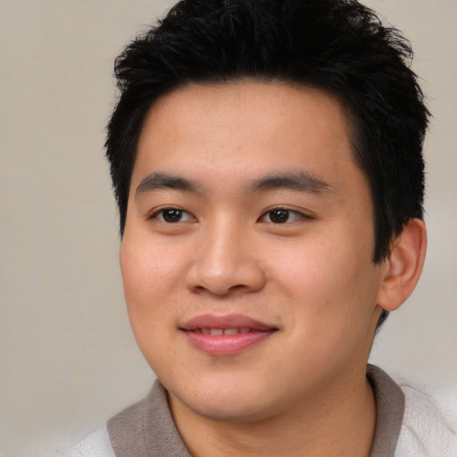 Joyful asian young-adult male with short  black hair and brown eyes