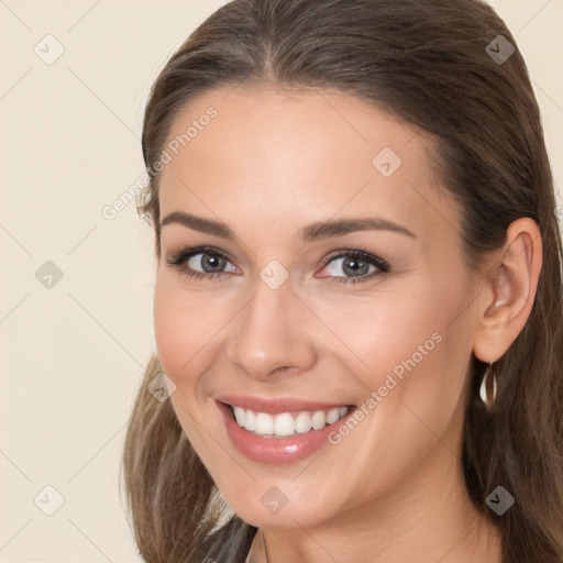 Joyful white young-adult female with long  brown hair and brown eyes